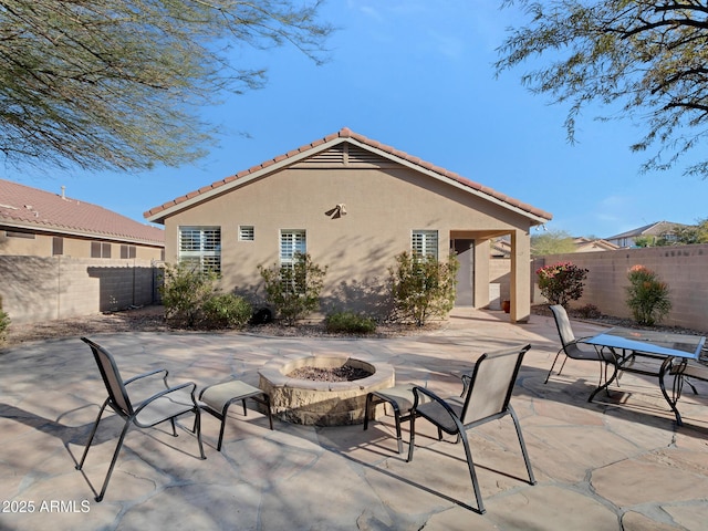 back of house with a patio and an outdoor fire pit