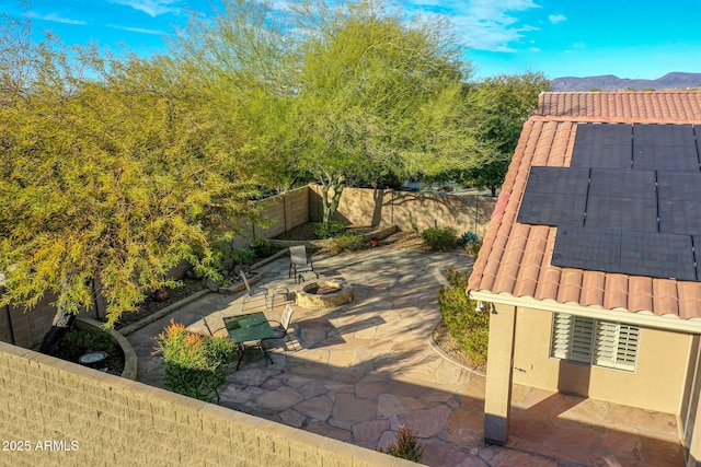 view of patio / terrace featuring a mountain view and a fire pit