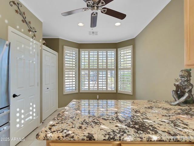 tiled bedroom featuring crown molding, a closet, ceiling fan, and stainless steel refrigerator