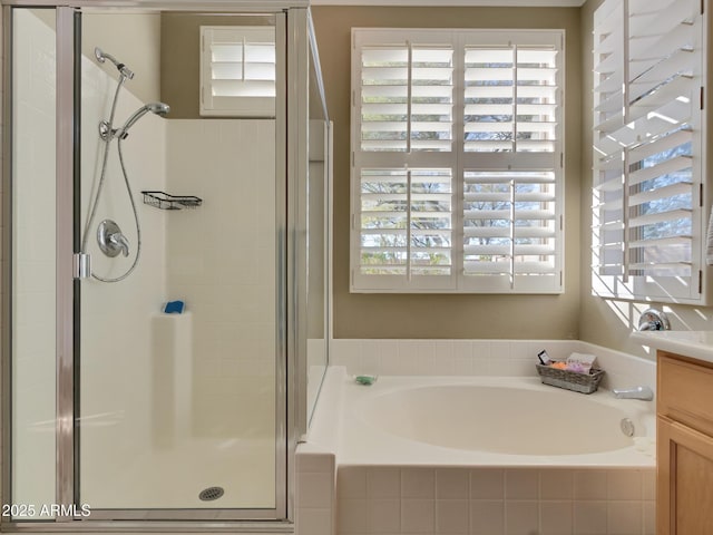 bathroom with vanity and separate shower and tub