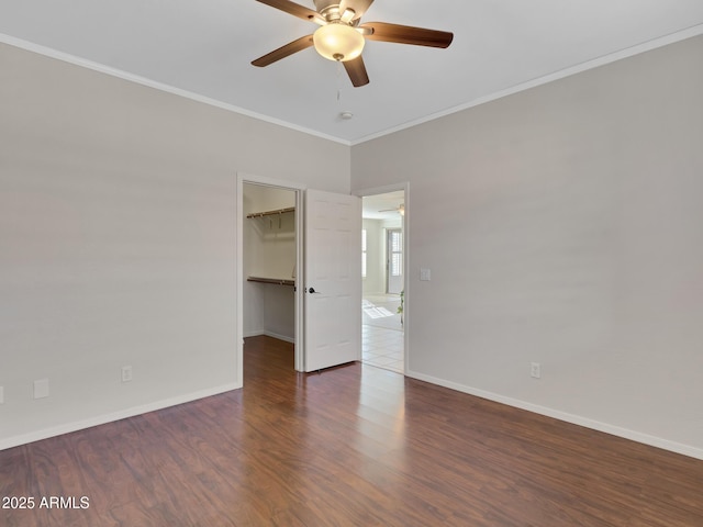 spare room featuring ceiling fan, ornamental molding, and dark hardwood / wood-style floors