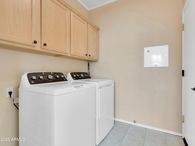 laundry room with cabinets, light tile patterned floors, and separate washer and dryer