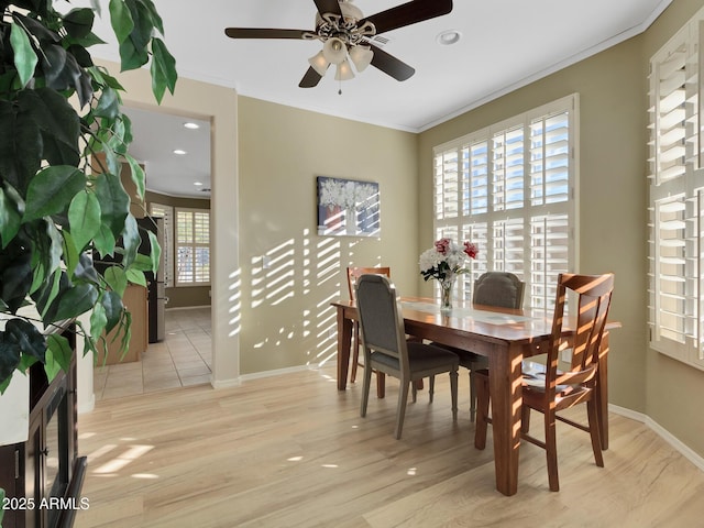 dining area with ceiling fan, crown molding, and plenty of natural light