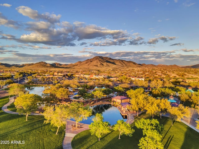 birds eye view of property with a water and mountain view