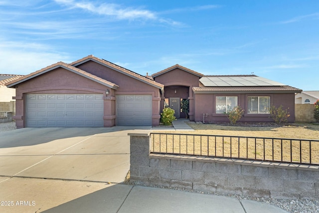 ranch-style home featuring a garage, a front lawn, and solar panels