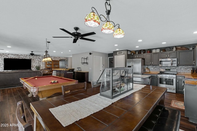 rec room featuring billiards, dark hardwood / wood-style floors, ceiling fan, and indoor bar