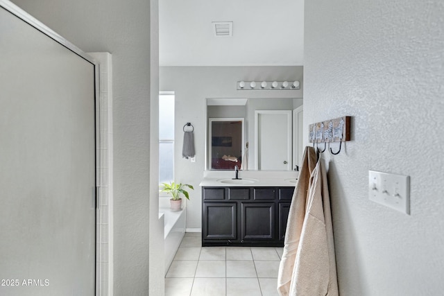 bathroom with vanity, tile patterned floors, and shower with separate bathtub