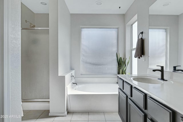 bathroom featuring vanity, separate shower and tub, and tile patterned floors