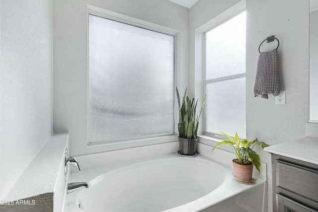 bathroom featuring vanity and a tub