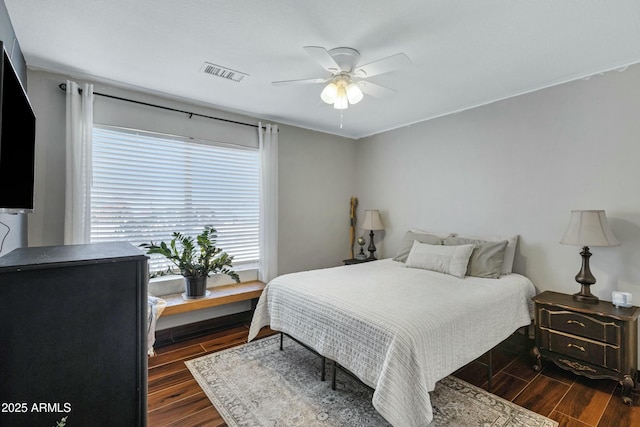 bedroom featuring dark hardwood / wood-style flooring and ceiling fan