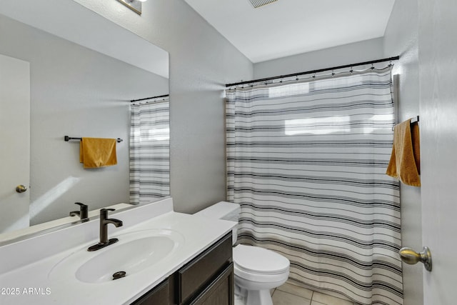 bathroom with a shower with curtain, tile patterned floors, vanity, and toilet