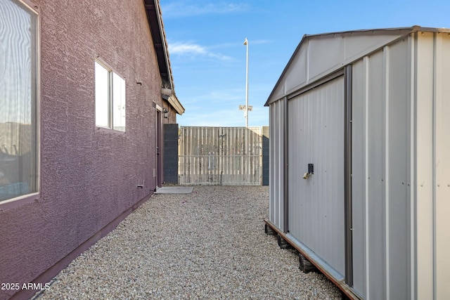 view of side of home featuring a shed