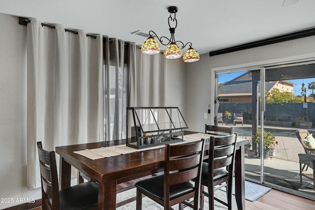 dining space with wood-type flooring