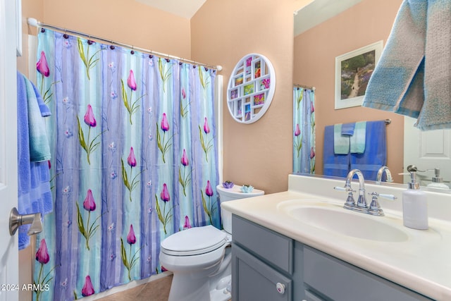 bathroom featuring a shower with shower curtain, tile patterned flooring, vanity, and toilet