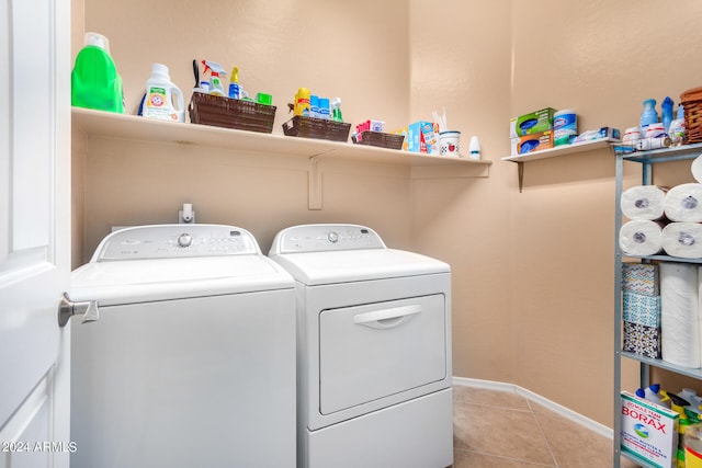 laundry area featuring independent washer and dryer and light tile patterned floors