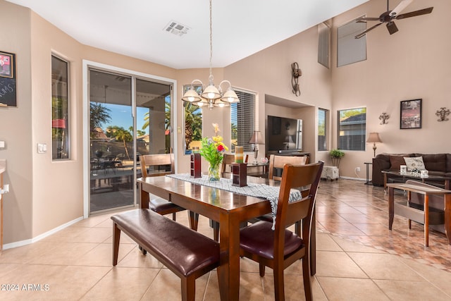 dining area featuring ceiling fan with notable chandelier, plenty of natural light, and light tile patterned floors