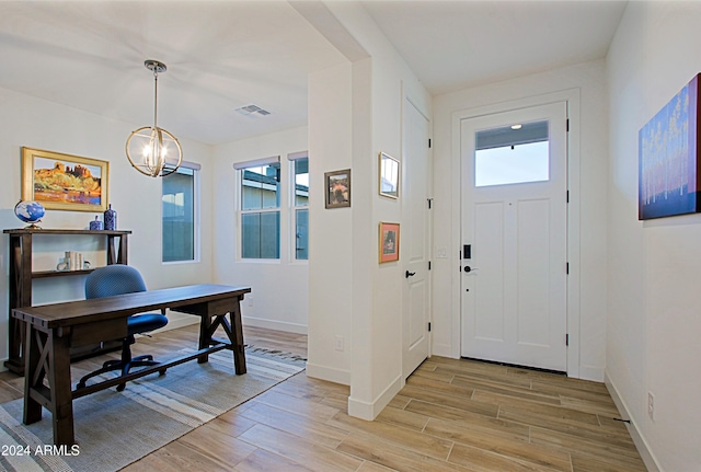 entrance foyer featuring a chandelier and light hardwood / wood-style flooring