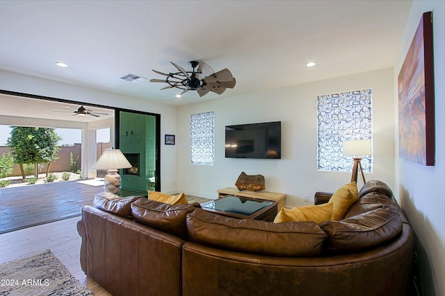 living room featuring ceiling fan and light wood-type flooring