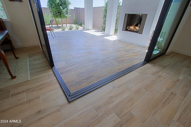 entryway featuring a fireplace and light wood-type flooring