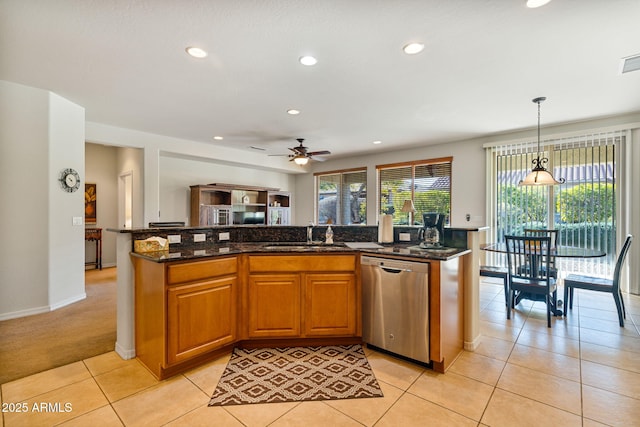 kitchen featuring pendant lighting, sink, stainless steel dishwasher, and a kitchen island