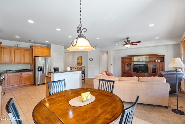 dining space featuring light tile patterned floors and ceiling fan