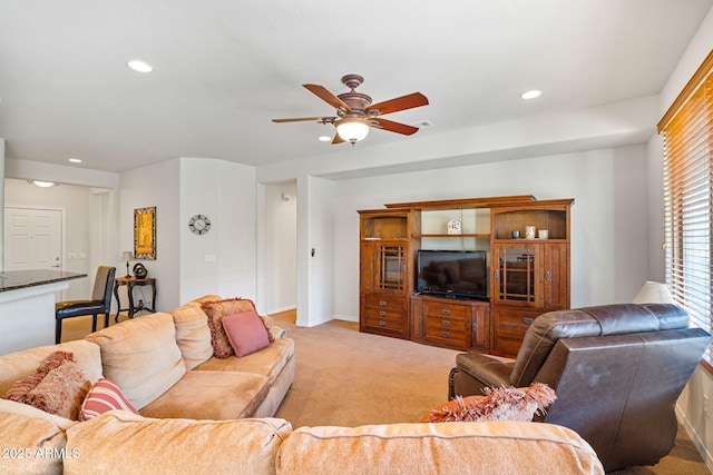 carpeted living room featuring ceiling fan