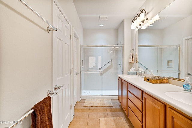 bathroom with tile patterned floors, an enclosed shower, and vanity