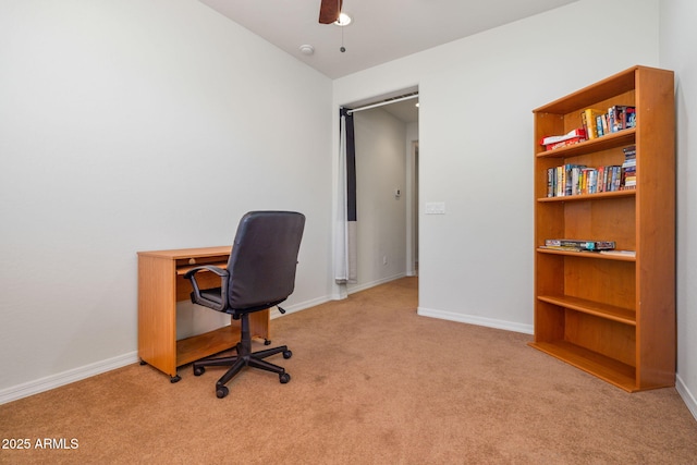 carpeted office space with ceiling fan