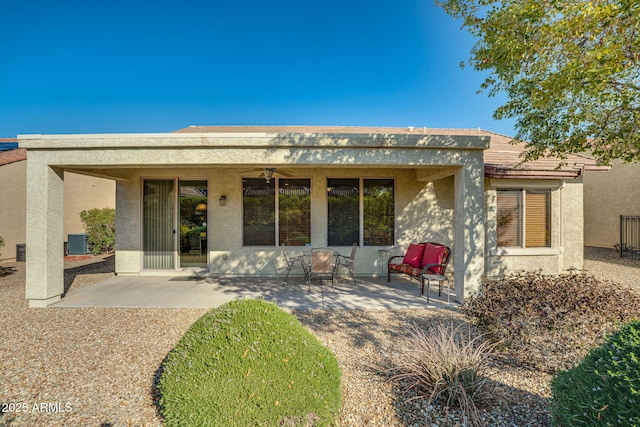 rear view of property featuring ceiling fan, a patio area, and central air condition unit