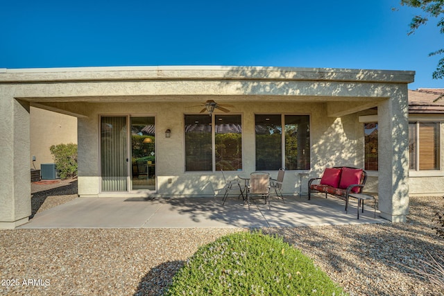 rear view of property with central AC unit, ceiling fan, and a patio area