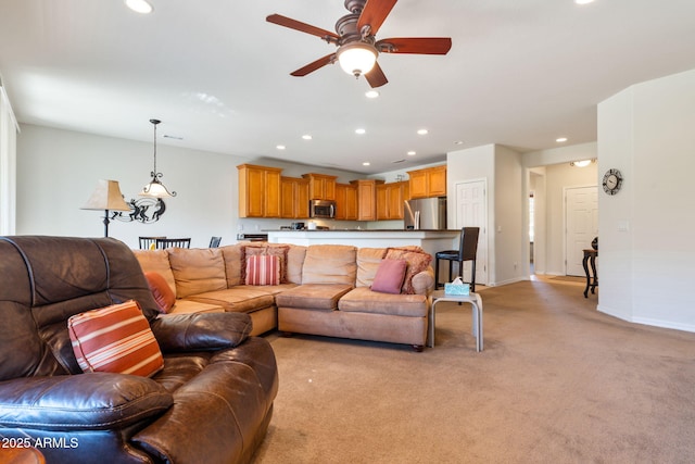 carpeted living room with ceiling fan