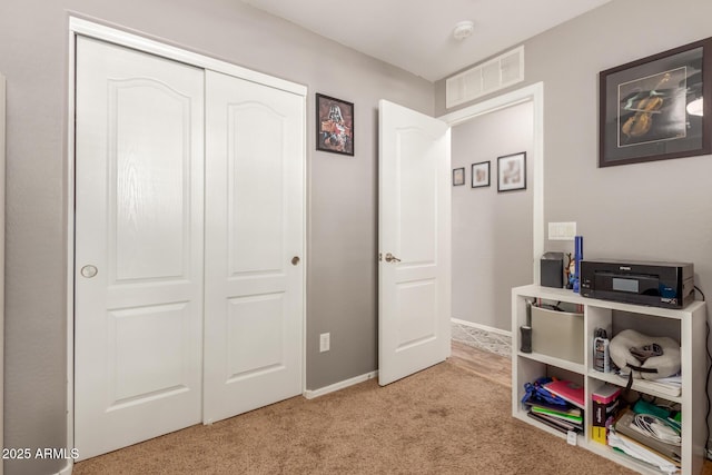 recreation room with light colored carpet