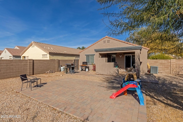 back of house with central AC and a patio