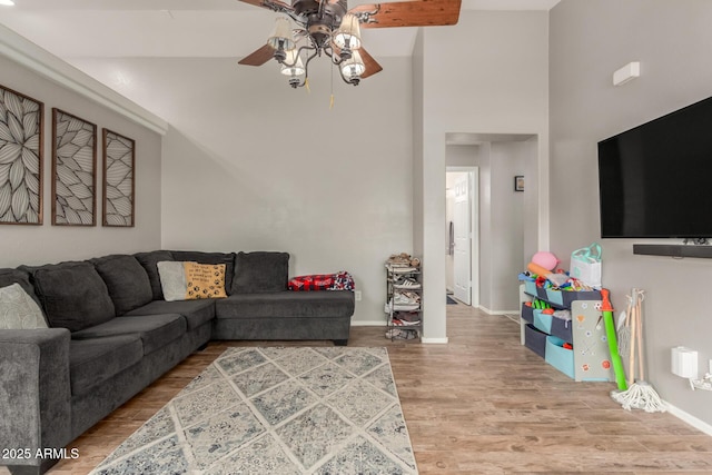 living room featuring ceiling fan and hardwood / wood-style floors