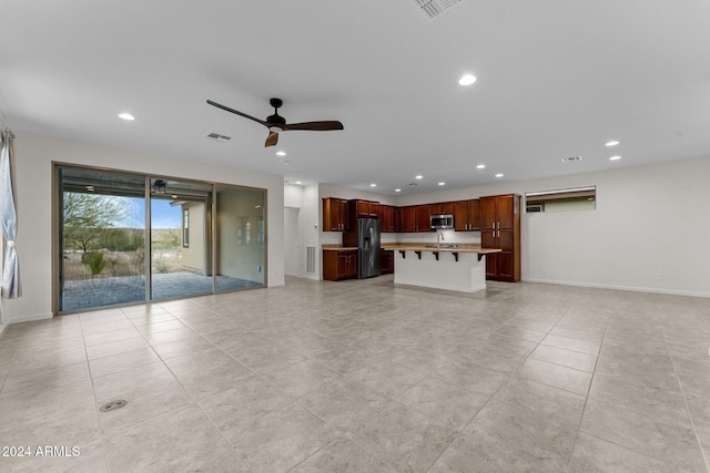 unfurnished living room with ceiling fan and sink