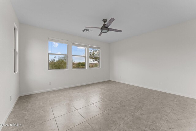 unfurnished room with ceiling fan and light tile patterned flooring