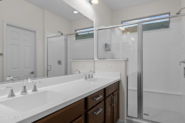 bathroom featuring vanity and an enclosed shower