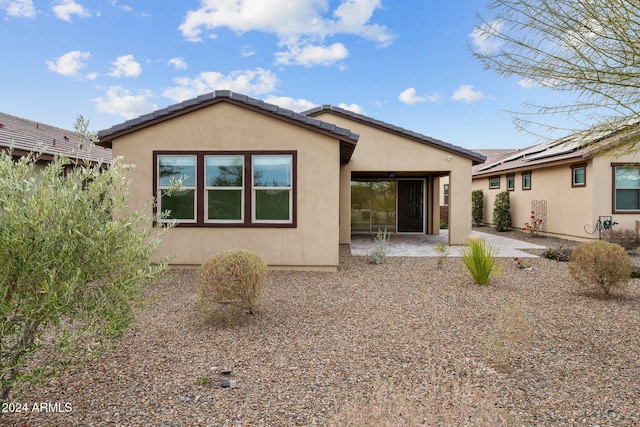 back of property featuring a patio area