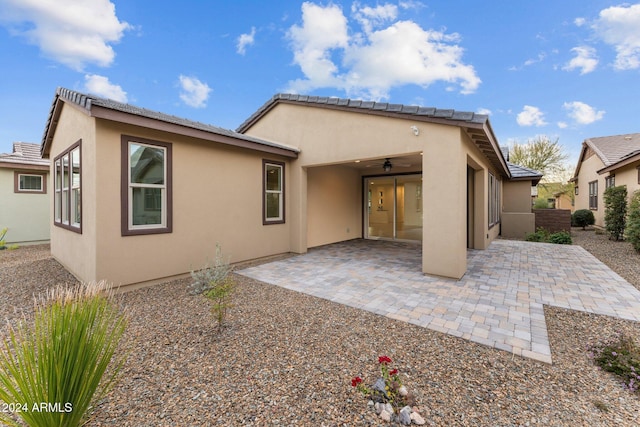 rear view of house featuring a patio and ceiling fan