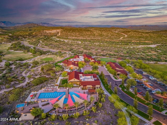 aerial view at dusk featuring a mountain view