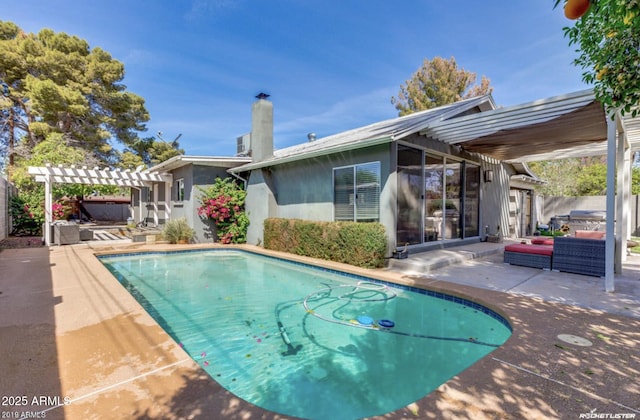 view of pool with a pergola, an outdoor hangout area, and a patio area