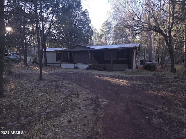 back of property with a sunroom