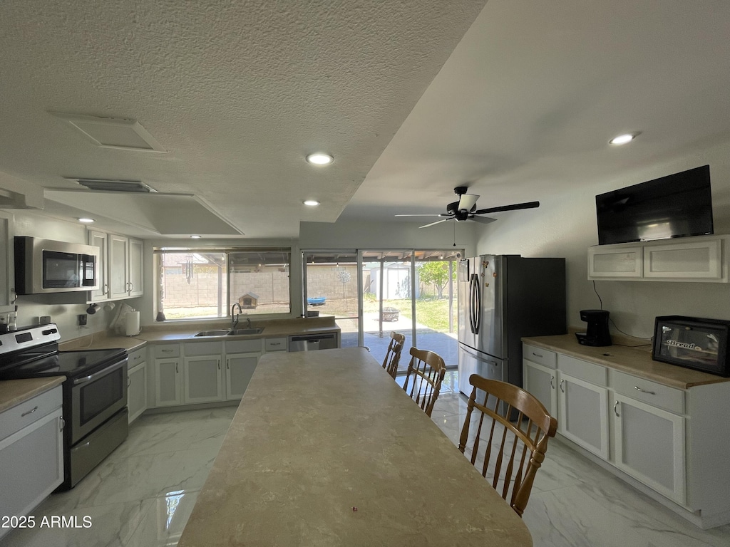 3738 W Danbury Dr, Glendale, AZ 85308 - kitchen with stainless steel appliances, light marble finish flooring, a sink, plenty of natural light, and recessed lighting