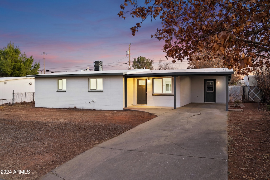 single story home with a carport and central air condition unit