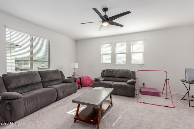 living room featuring light carpet, ceiling fan, and a healthy amount of sunlight