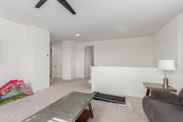 carpeted living room with ceiling fan