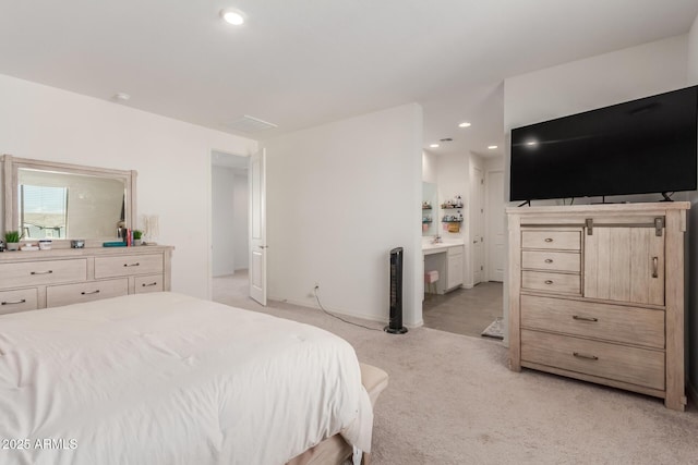 carpeted bedroom with connected bathroom