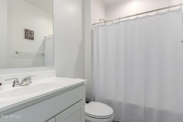 bathroom with vanity, toilet, and walk in shower