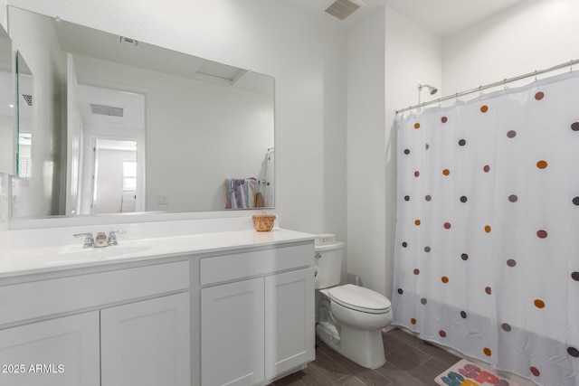 full bathroom with hardwood / wood-style flooring, shower / tub combo with curtain, vanity, and toilet