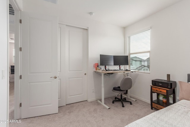 bedroom featuring light colored carpet and a closet